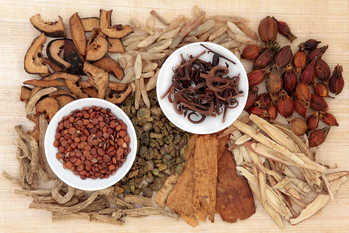 Several colorful piles of different dried herbs